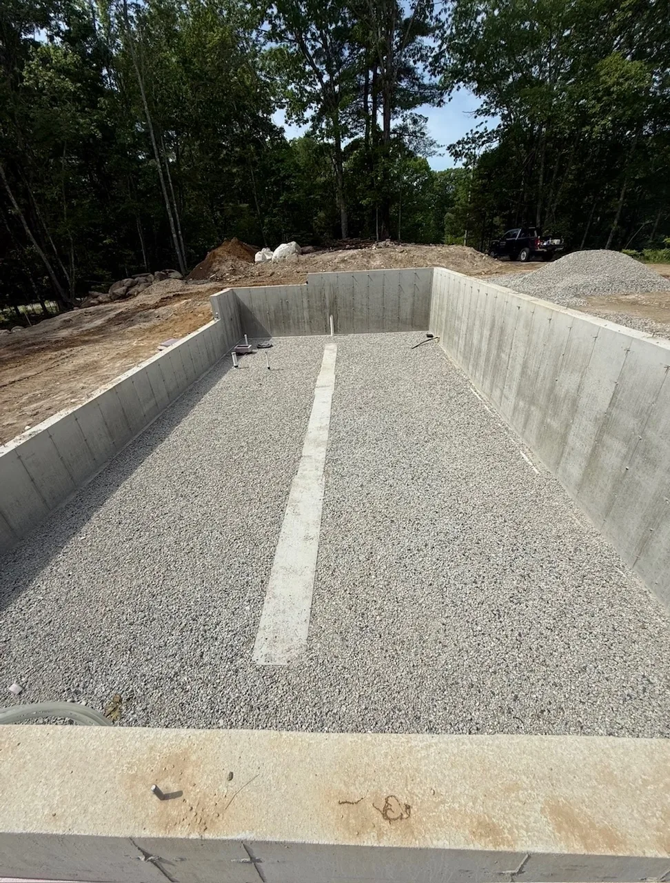 Foundation walls poured with the floor stone placed and levelled